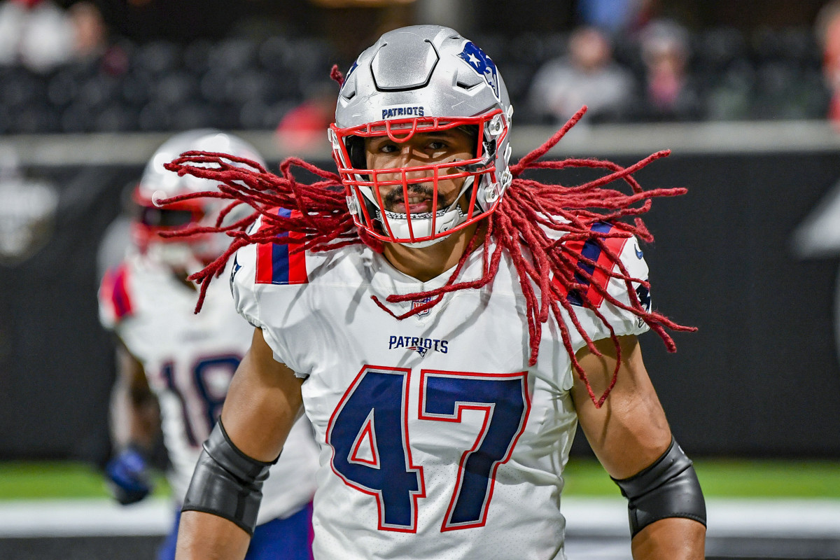 Jakob Johnson's red dreadlocks bounce during a pre-game warmup